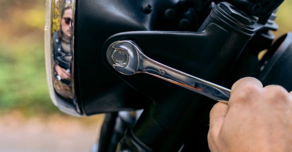 Motorcycle Chrome Maintenance Tips. - A Person Tightening Screws of a Motorbike