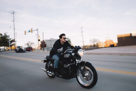 Motorcycle In Traffic - man riding cruiser motorcycle at the road during day