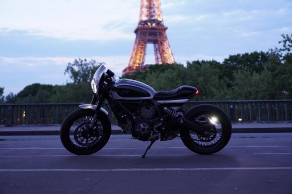 Motobike - black cruiser motorcycle parked on gray pavement during daytime