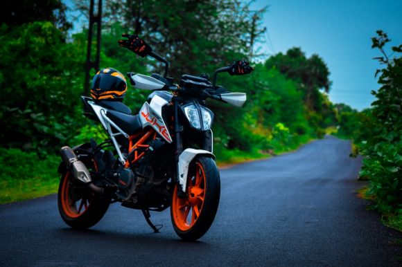 Motorcycle Helmet - black and orange motorcycle on road during daytime