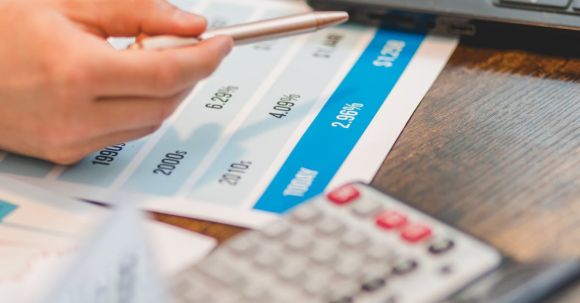 Factors, Rates - A Close-Up Shot of an Agent Pointing Rates with a Ballpen