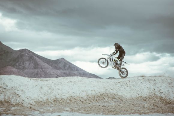 Dirt Bike - man in black jacket riding on bicycle during daytime