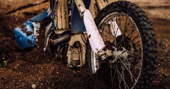 Motorcycle Accident Guide - Blue Motocross Dirt Bike on Mud