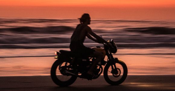 Motorcycle Overheating: Actions - Man Riding Motorcycle on Beach during Sunset