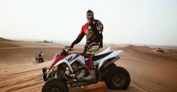 Motorcycle Suit Features - Man in helmet on quad bike in desert