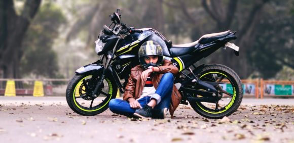 Sport Motorbikes - man lying beside black motorcycle