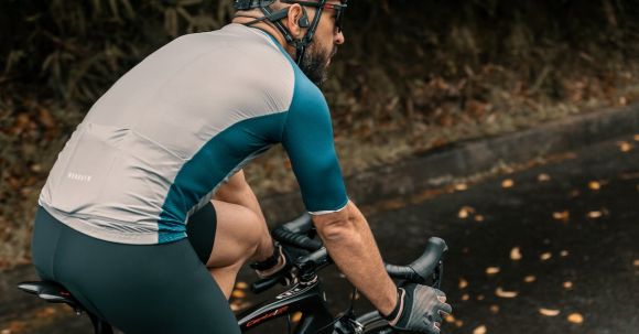 Riding Gloves. - Man in Sportswear and Helmet Riding a Bicycle