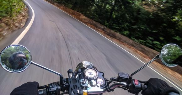 Smoothest Motorcycle. - Person Driving Motorcycle on Curved Concrete Road Near Trees